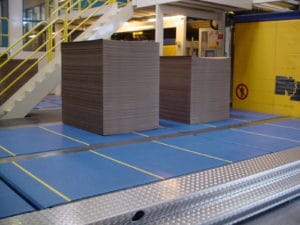 Automated conveyor system in modern cardboard warehouse production plant.